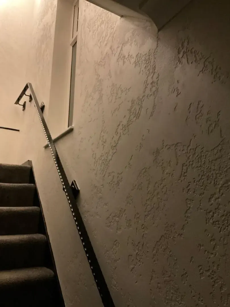 Raised wall texture beside a staircase