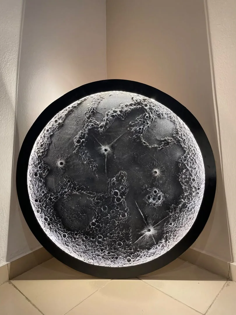 Circular textured artwork illuminated with cool white light